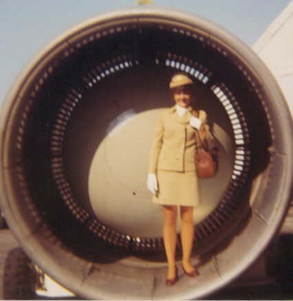 1970s Susanne Malm poses for a photo in a Pan Am Boing 747  engine that has been specially prepared for a ferry flight attached to the wing of another aircraft.  Pan Am would ferry engines around the world in this manner.  Engines would be ferried for specific aricraft that were grounded due to engine trouble or also as part of a pro-active maintenance program to keep spare engines available at major stations around the world for aircraft in need.